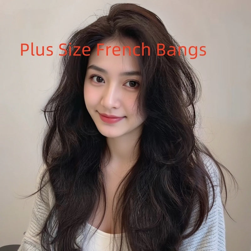 Young woman with long curly hair and plus size French bangs, showcasing a natural hairstyle style.