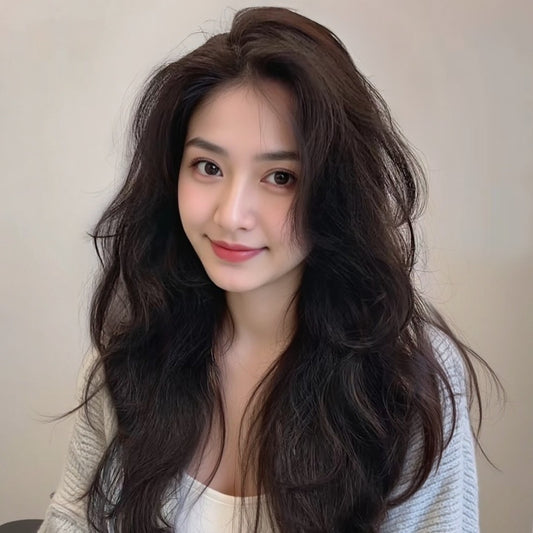 Long curly full human hair wig displayed on a woman with dark hair and a natural makeup look.